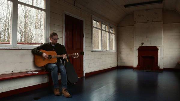 Gareth Davies-Jones in the Haltwhistle Waiting Rooms with Guitar